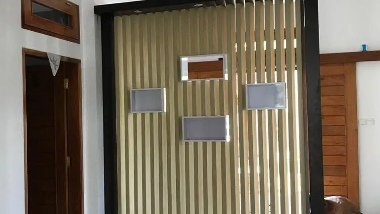 Slatted timber partition beside a doorway