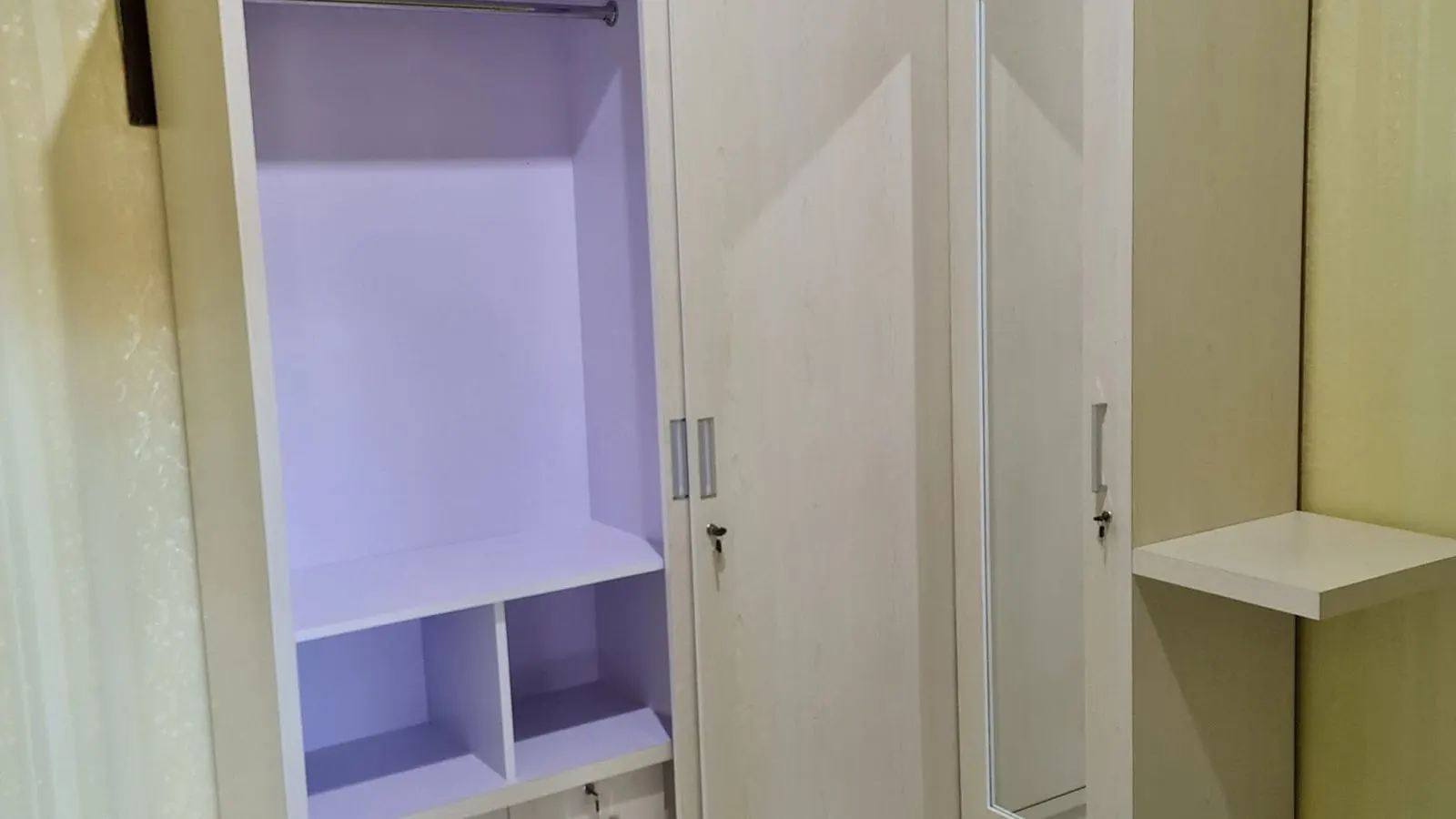 Custom wardrobe with sliding mirror door and open shelving