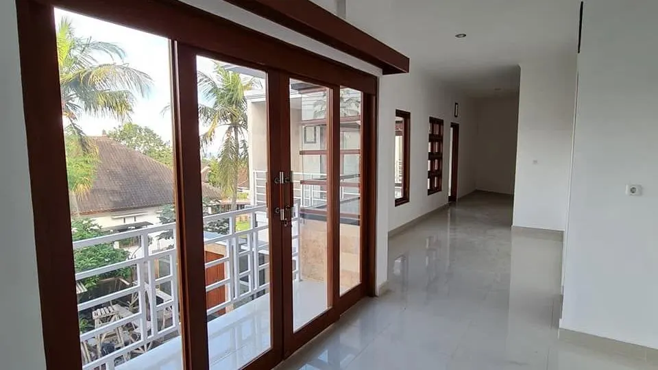 Finished room with timber sliding doors opening onto a balcony
