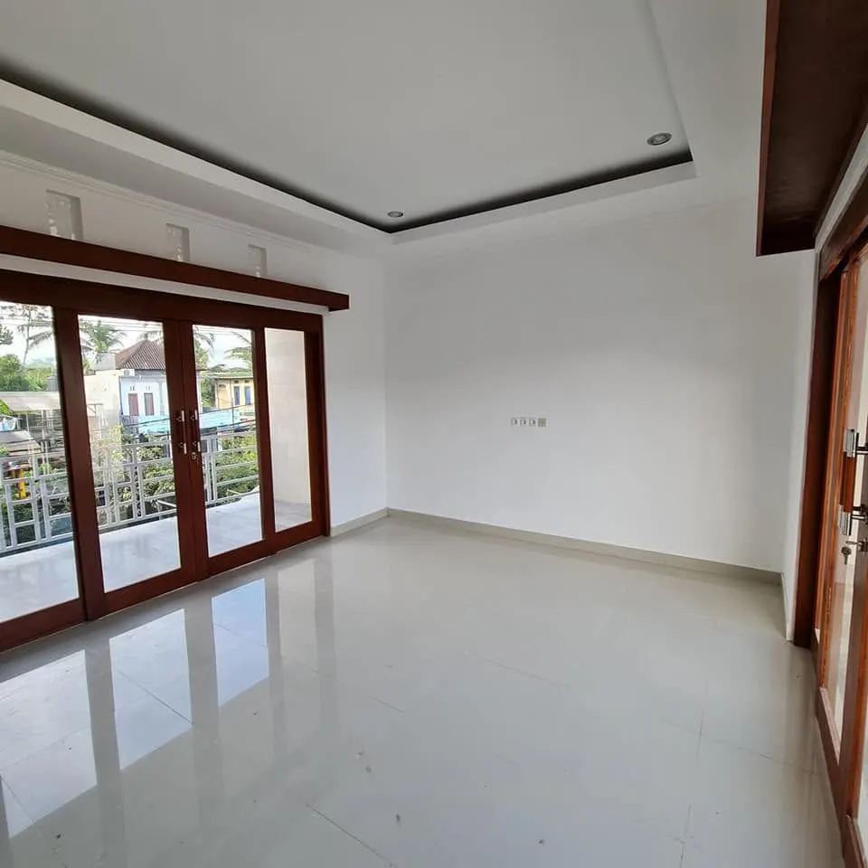 Finished room with tiled floor and sliding doors